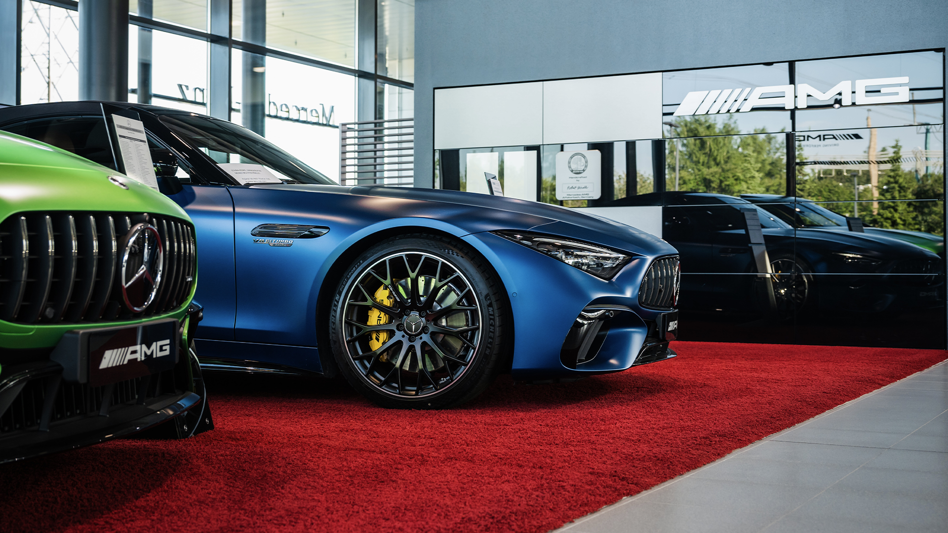 Jauns Mercedes-Benz AMG zilā krāsā Veho auto salonā uz sarkana paklāja