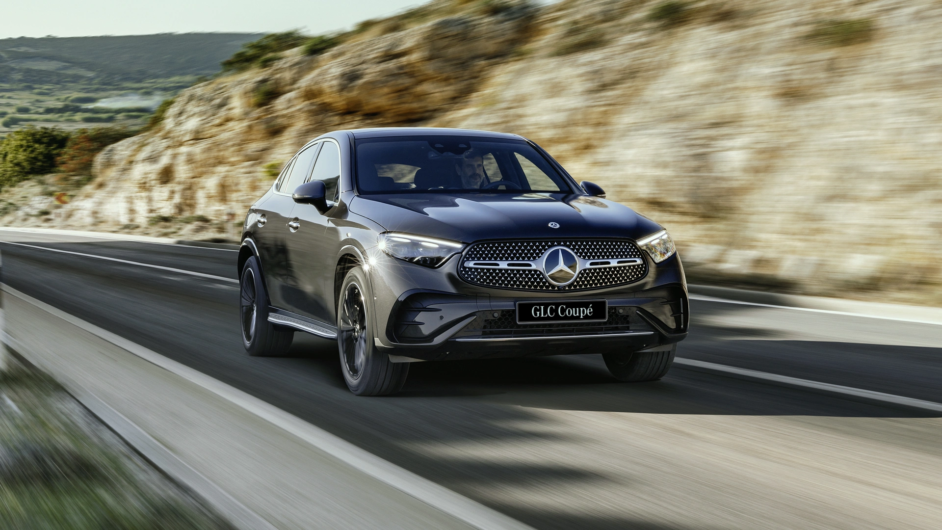 Black GLC driving on a highway